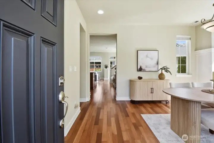 Welcoming front entry with cherry-inspired floors, crisp white millwork, and a light-filled interior at this Mill Creek WA home for sale.