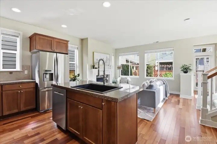Open-concept kitchen with abundant cabinetry, stainless steel appliances, and multiple windows bringing in year-round natural light.
