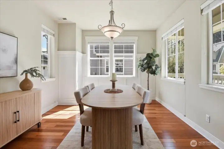 Sunny dining area surrounded by windows, creating an airy and uplifting everyday dining space in this Mill Creek Northpointe home.
