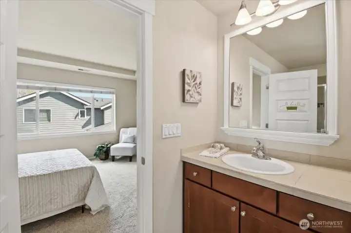 Primary bath vanity and bedroom connection, highlighting the functional layout of the ensuite in this Mill Creek home.