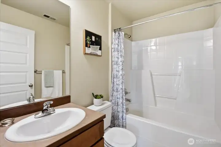 Full upstairs bathroom with vanity and tub-shower combination serving the secondary bedrooms.