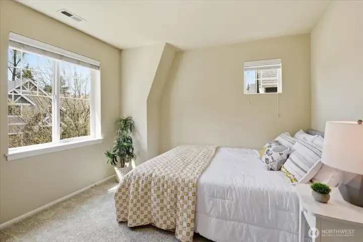 Third bedroom with large window, natural light, and comfortable layout in this thoughtfully designed upstairs floor plan.