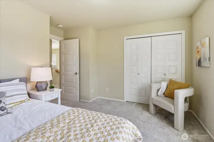 Bright third bedroom with closet, neutral palette, and versatile space for guests, home office, or playroom use.