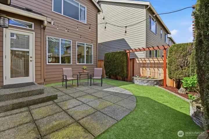 Backyard view of the home featuring a patio, tidy lawn area, and easy-care outdoor living space in Northpointe.