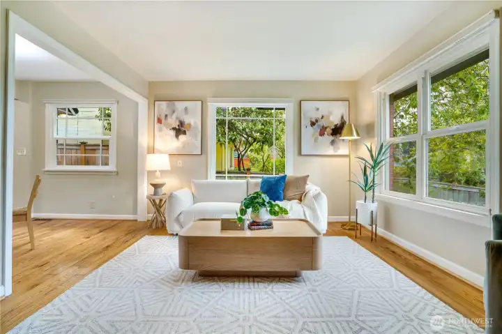 Newer vinyl windows let in the sunshine and gorgeous original wood floors add warmth and personality.