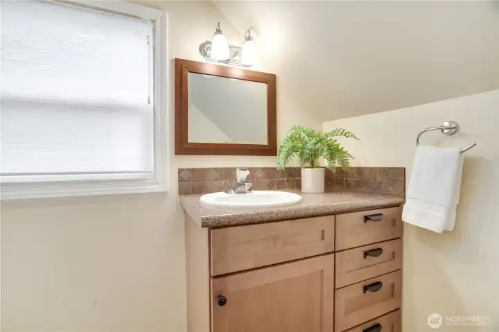 Newer 3/4 bathroom with shower stall in the upstairs suite.