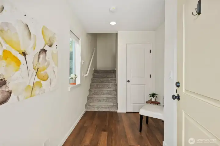 Light-filled entry with modern flooring, neutral tones, and convenient access to main living areas.