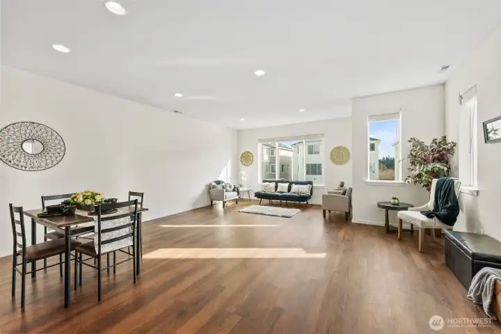Bright and airy living room anchored by large windows—perfect for relaxing or entertaining.