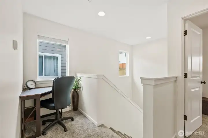 Versatile upper landing with built-in workspace—perfect for a home office, study nook, or flex space.