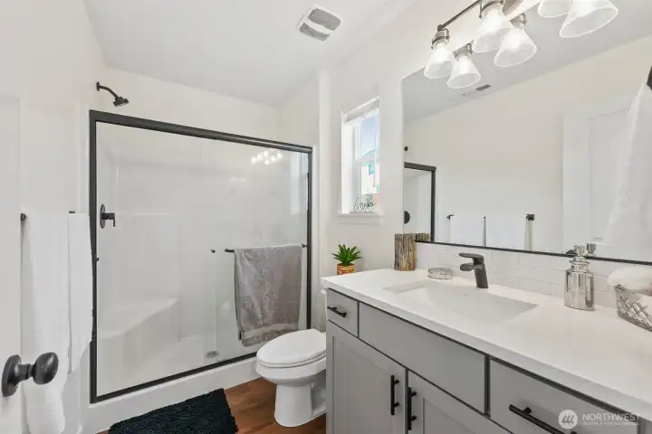 Stylish primary bath with walk-in shower, modern vanity, and clean finishes.