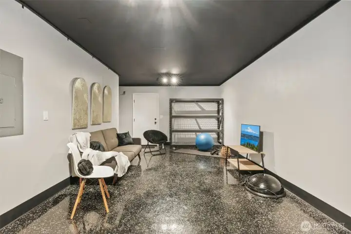 Versatile garage space with epoxy floors—ideal for a gym, workshop, or additional storage.