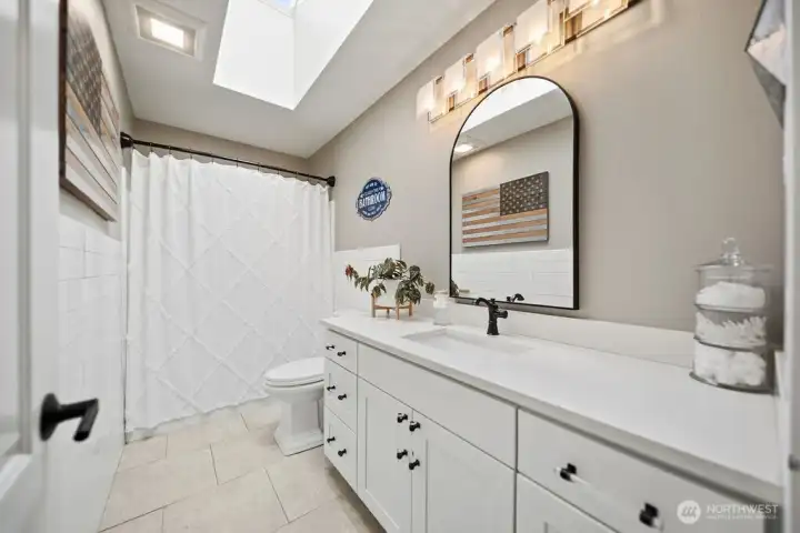 Hall bathroom with newer lighting, vanity and mirrors. Hall bathroom with newer lighting, vanity and mirrors.