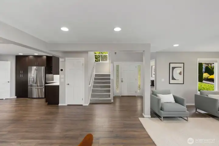 Front door with stairs to the left and a half bath to the right for guests.