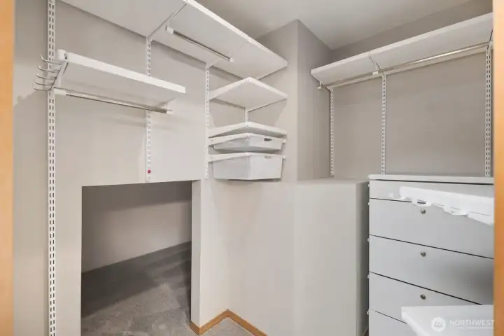 Massive closet with even more storage tucked back.