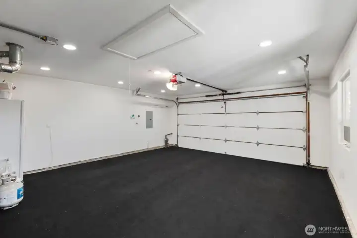 Finished garage with windows for light, extra storage through ceiling hatch.