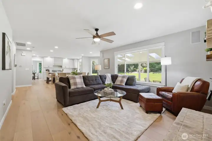 Open-concept layout that seamlessly connects to the kitchen and eating nook. Gather around the cozy wood-burning fireplace on cool Northwest evenings or enjoy year-round views of the lush outdoor setting. Filled with natural light and thoughtfully updated throughout, this welcoming family room is the heart of the home.