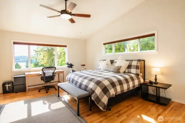 The primary bedroom is one of many sun-filled spaces offering spectacular views of the Sound.