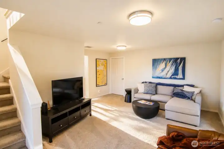 The home’s lower main room provides an open, welcoming area for everyday use.