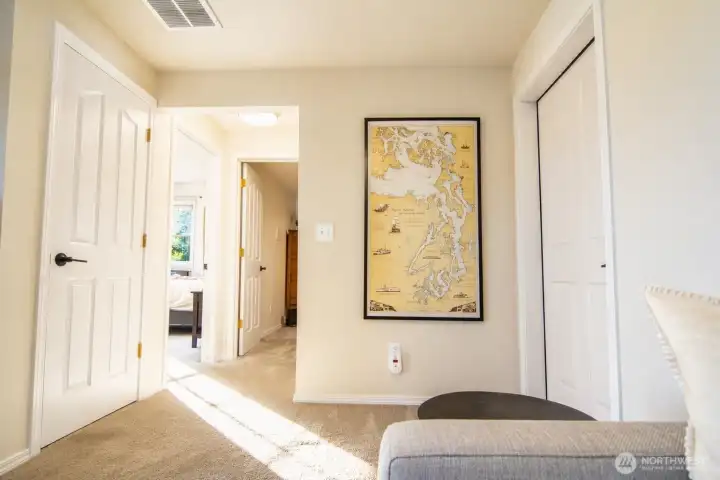 The lower hallway provides a simple, welcoming passage through the home.