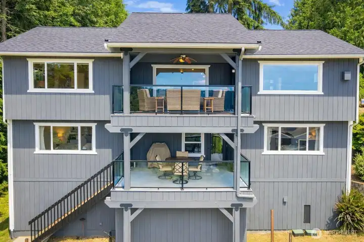 Rear elevation of the home with well-maintained grounds and outdoor living areas.