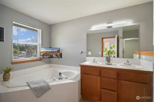 Primary bathroom with soaking tub and double vanity.