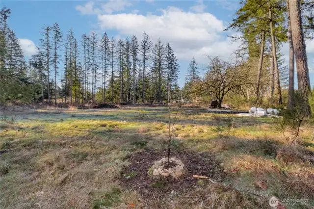 Well head in place on the right and the septic design puts the septc will be all the way in back in front of the tall trees