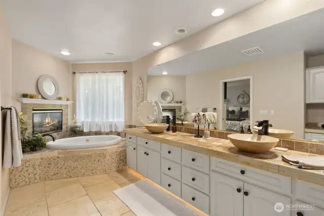 The 5-piece ensuite bath feels like a private spa, complete with dual vanities, a soaking tub, walk-in shower, and a spacious walk-in closet.