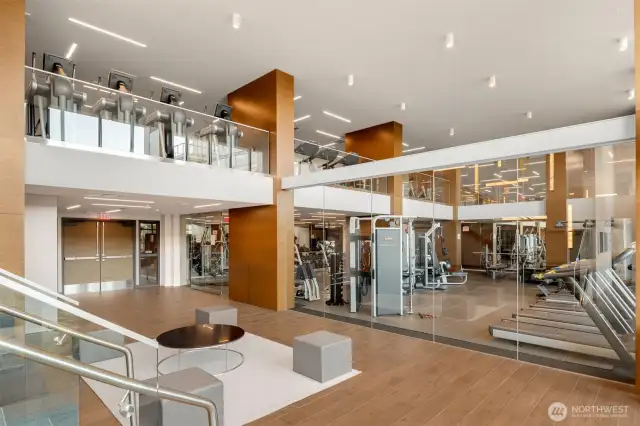 Gym with yoga room and pilates reformer machines.