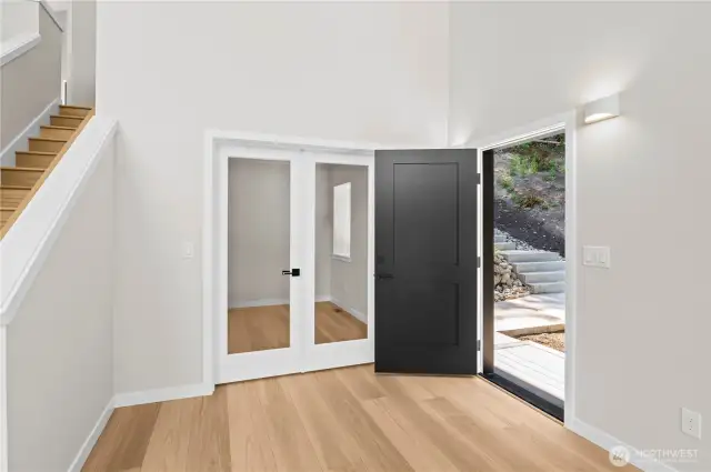 Main floor office has clear French doors to enjoy the incredible Lake Howard view