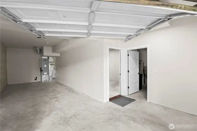 The garage/workshop area is to the left. To the right are doors leading to downstairs utility room and basement.  There is exterior access to this area and stairs leading to the main floor.