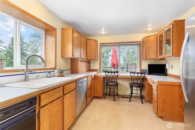 The kitchen features a large pass-through window out to the deck - great for BBQs and entertaining!