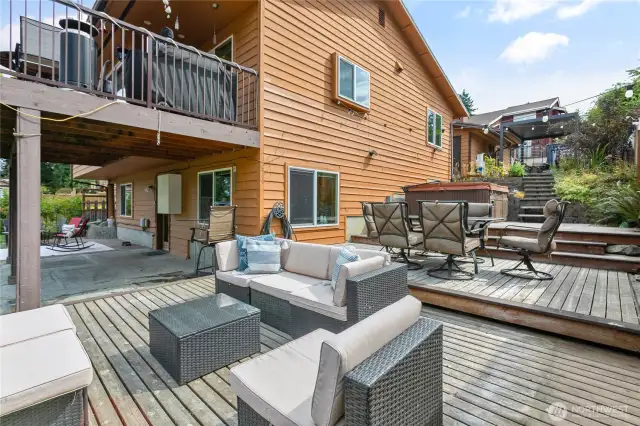 Seen here is the upper deck with patio beneath and the large multi-level side deck!