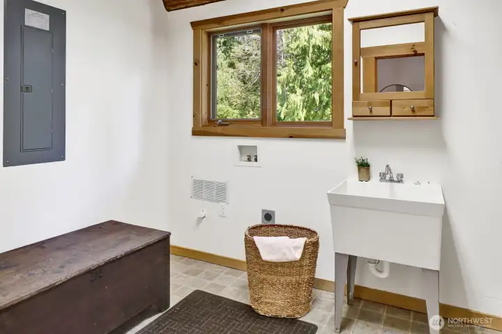 The utility room is large and has space for a new washer/ dryer, sink, hot water tank, and access to the fully finished crawl space