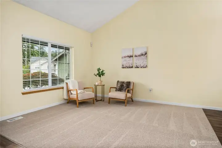 A closer look at the oversized front window emphasizes the amount of light this room receives. The clean wall lines and spacious layout make it easy to envision multiple furniture arrangements.