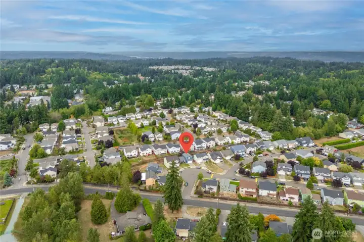 Wider aerial shot displays the home within the desirable Novella neighborhood. Surrounded by nearby parks, schools, and amenities, the location balances community feel with convenience.