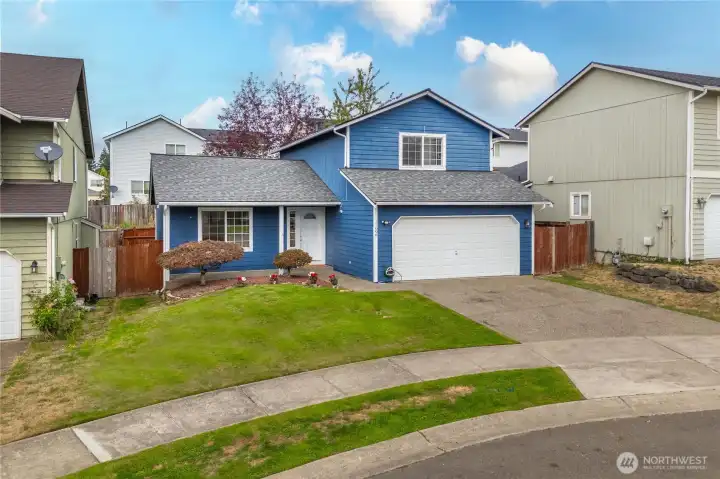 Set on a cul-de-sac, the home’s exterior combines charm and practicality, with a spacious driveway, tidy landscaping, and fully fenced side yard access.