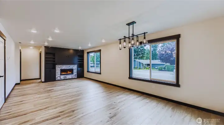 Great room with gas fireplace opens to dining area
