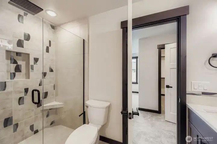Primary suite bath with jetted tub, rain shower & heated towel rack
