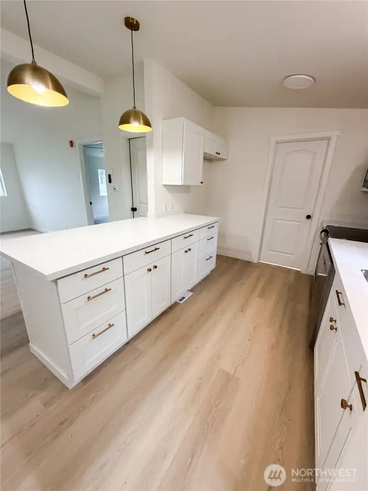 Kitchen leading to pantry and washer/dryer