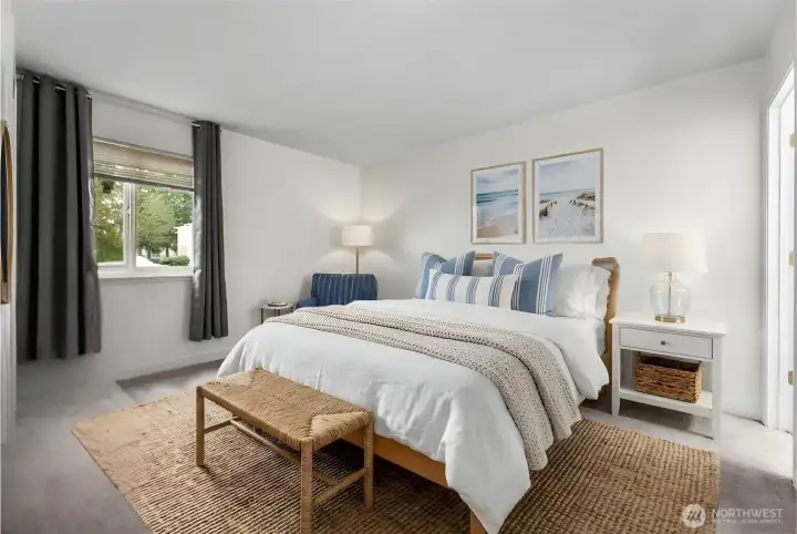 Main bedroom features brand-new carpet, fresh white paint, walk-in closet, & additional access door to the bathroom. Virtual staging to showcase potential furniture placement.