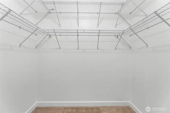 Walk-in closet offers great storage space and organization with new shelving.