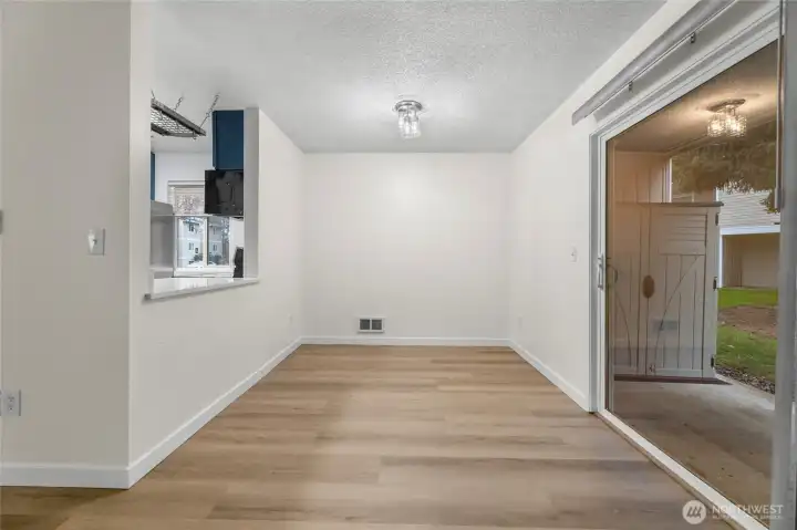 Updated dining area with space for breakfast bar. Sliding door directly to patio offers additional natural light