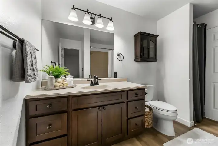Updated bathroom with new vanity and clean, functional design & plenty of storage.
