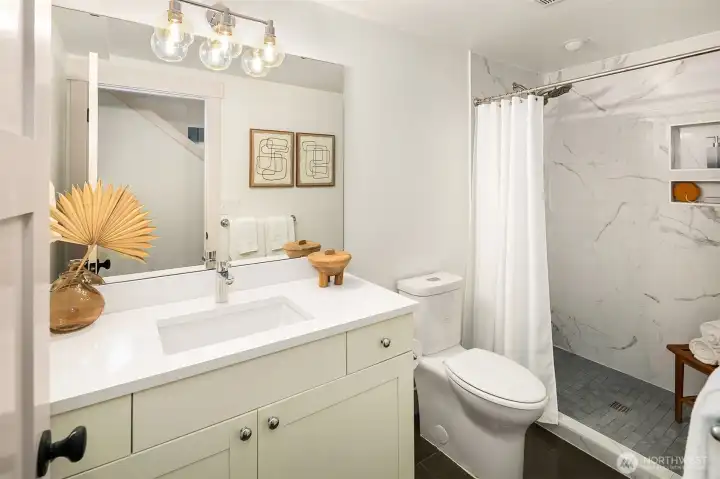 Downstairs bathroom with step in shower.