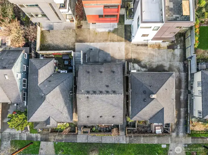 Aerial shot showing garden in front and parking in back.