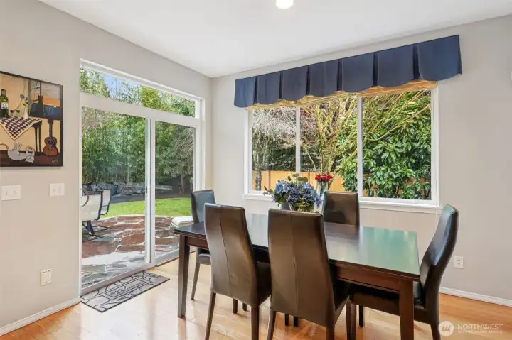Lovely dining nook leading out to patio and backyard.