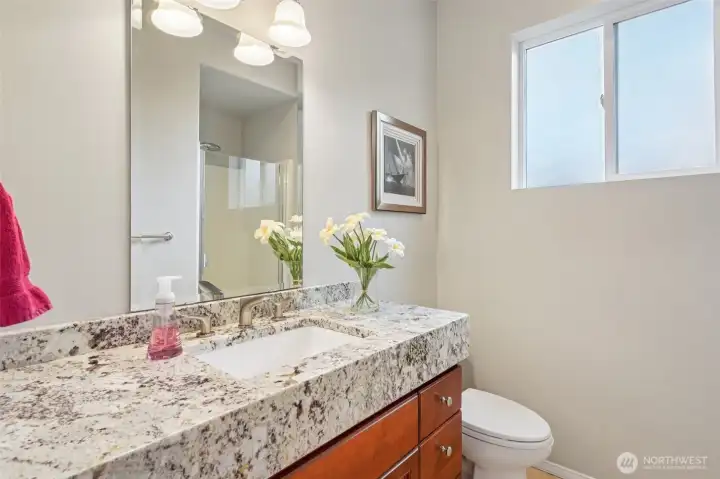 Main level 3/4 bath adjacent to bedroom providing versatility.