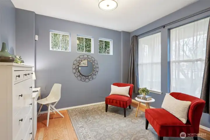 Main floor den featuring five windows for an abundance of natural light, creating a very inviting atmosphere.