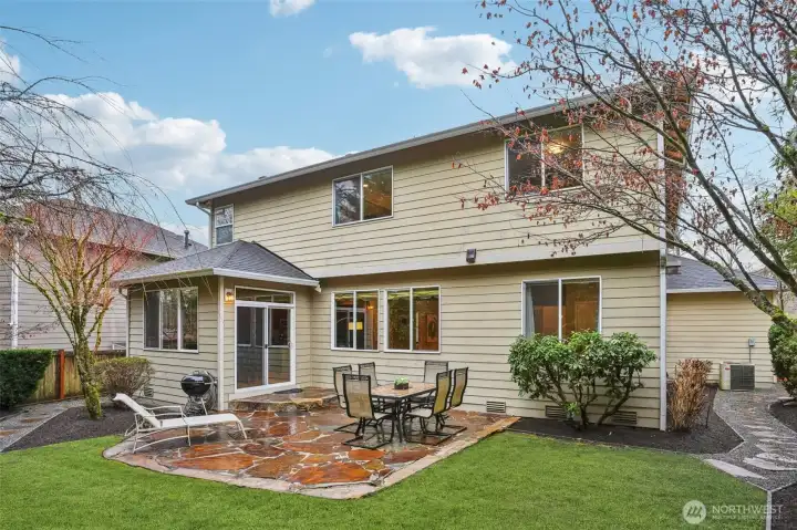 Luxurious stone slab patio in very private backyard next to greenbelt, and no neighbors to the rear.