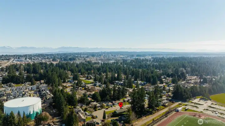 A final aerial view showing the broader area around the home.